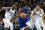 Wolves guard Anthony Edwards drove past Dallas’ Reggie Bullock (25) and Jalen Brunson on Friday night at Target Center.
