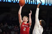 Annandale forward Robert Olson got a shot off againast Minneapolis North’s Jacob Butler during Saturday’s Class 2A championship game at Williams A