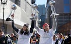 Seimone Augustus, left, and Maya Moore held up three of their WNBA trophies during a 2015 championship parade.