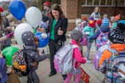 Lake Harriet Lower Principal Angie Ness welcomes students back to school on Tuesday. Minneapolis students returned to school following a three-week te