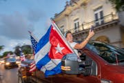 Members of the ‘Gran Caravana,’ (Big Caravan), pass the Cuba-centric San Carlos Institute on Duval Street Wednesday, July 14, 2021, in Key West, F