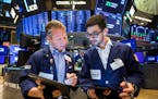 In this photo provided by the New York Stock Exchange, traders Robert Charmak, left, and Orel Partush compared data late last month.