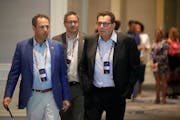 Vikings co-owners Mark Wilf, left, and Lenny Wilf, right, with the team’s chief operating officer, Andrew Miller, at the league meetings this week.