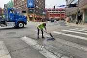 Crews patched potholes in crosswalks and the intersection of 7th Street and 1st Avenue N. near Target Center last week.