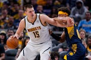 Denver center Nikola Jokic drove against Indiana’s Justin Anderson on Wednesday during the visiting Nuggets’ victory.