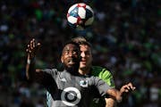Minnesota United defender Romain Metanire (19) and Seattle Sounders forward Jordan Morris (13) competed for a header during the final game of the 2019