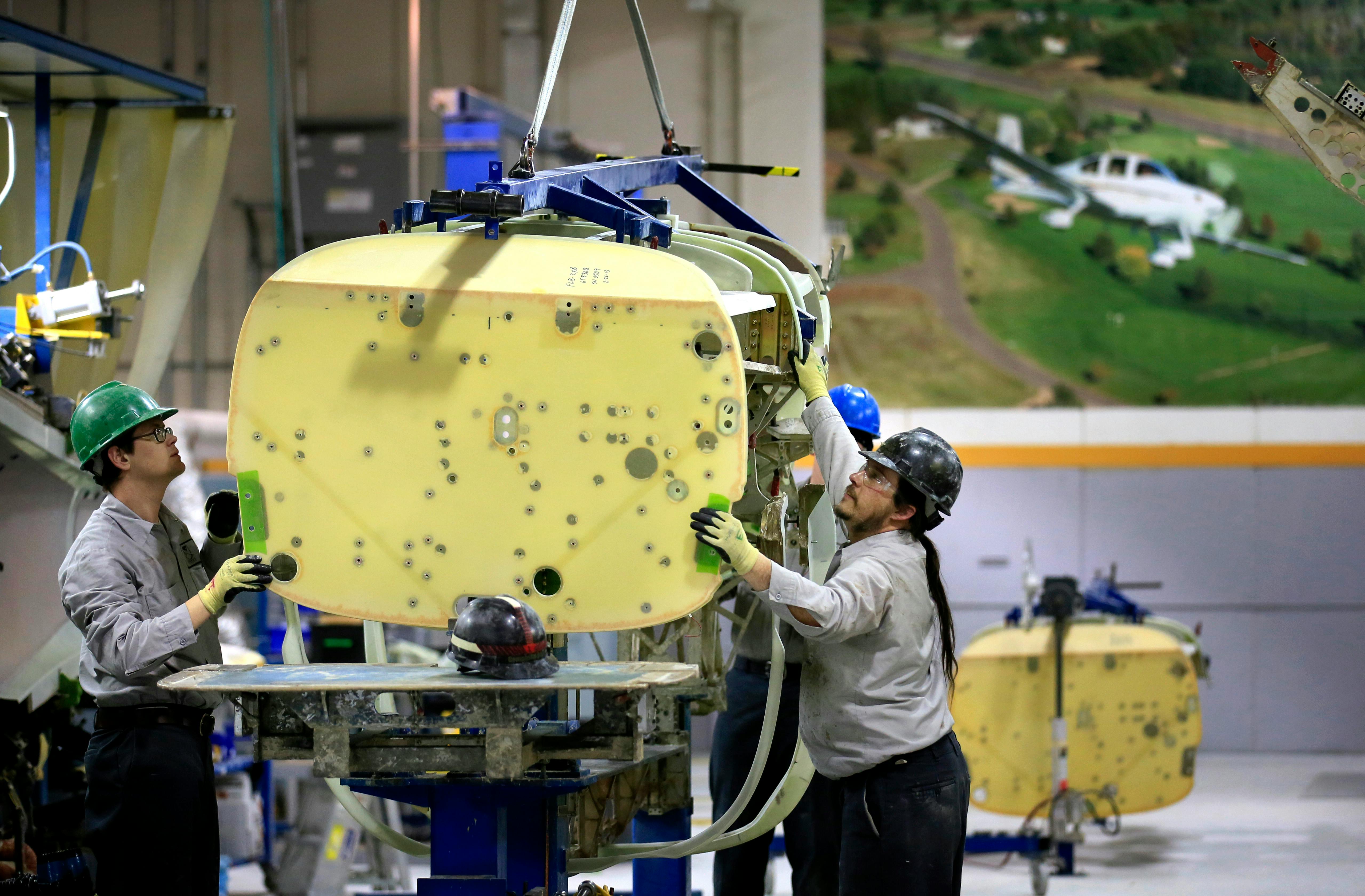 Workers at Cirrus Aircraft in Duluth assemble one of the company's aircraft in 2012.
