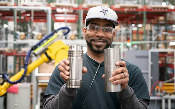 Corry Whitaker shows the before and after of a stainless steel piece of an industrial power sprayer. ] GLEN STUBBE • glen.stubbe@startribune.com Thu
