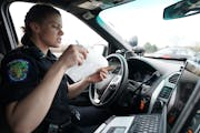 During a 2019 enforcement effort, Eagan officer Kirsten Dorumsgaard printed a ticket for a motorist who had been typing on a phone while driving.