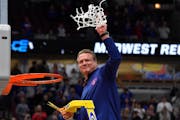 Kansas coach Bill Self took the final snip of the net after his Jayhawks defeated the Miami Hurricanes 76-50 to win the NCAA Midwest Regional champion