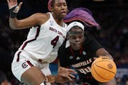 South Carolina star Aliyah Boston was a force on offense and defense Friday, including this moment against Louisville’s Olivia Cochran.