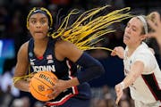 UConn’s Aaliyah Edwards gets past Stanford’s Lexie Hull during the second half. 