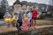 The Solarz-Patel family outside their new home in Edina. From left, Louis, 7, Milan, Amy, Lauren, 7, and Asher, 12. Mazie Solarz-Patel, 15, is not pic