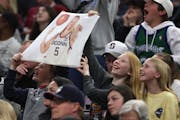 Young fans held a sign for UConn star guard Paige Bueckers during the NCAA women’s basketball championship game Sunday night at Target Center.