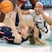 UConn guard Paige Bueckers passed under pressure from South Carolina forward Victaria Saxton during Sunday’s championship game at Target Center.