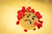 A COVID-19 virus made from a pin cushion decorated the entrance of the ICU at Regions Hospital in St. Paul in late 2020.