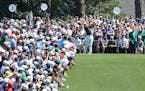 The gallery packs around the first tee watching five-time Masters champion Tiger Woods for a practice round.