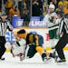 Minnesota Wild’s Nicolas Deslauriers (44) and Nashville Predators’ Mark Borowiecki, top, fall to the ice during one of four fights inn Tuesday’s