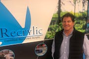 CEO Bill McNeely Jr. of Acrylic Design posed in the showroom with the new Recrylic recycled-product display that he said is just as good, cuts energy 