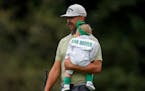 Erik van Rooyen carried his daughter Valerie during the Par 3 contest at Augusta National Golf Club on Wednesday.