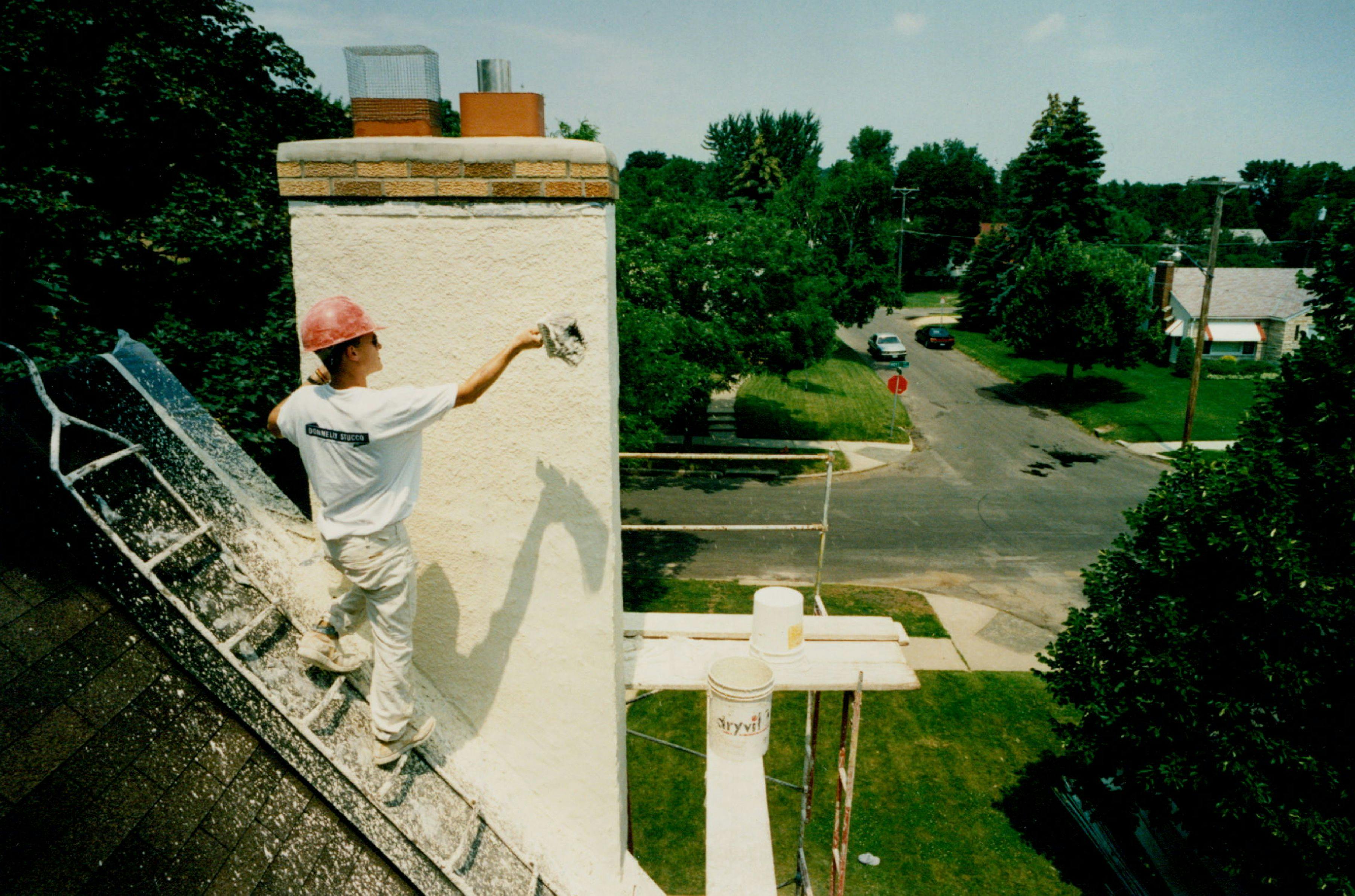 A Donnelly Stucco Company employee applies stucco to a home in St. Paul in 1992.