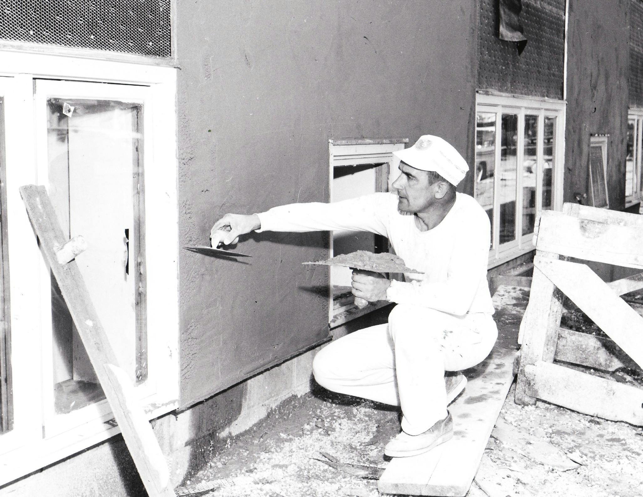 A worker applying stucco to a Twin Cities building in 1962.
