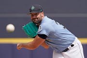 Seattle Mariners starting pitcher Robbie Ray throws during the first inning of a spring training baseball game against the Texas Rangers Monday, March