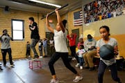 Northside Boxing Club coach Mohammed Kayongo, left, encouraged youth including sisters Aatiqah Haji, 10, right to left, and Fatima Haji, 13, during a 