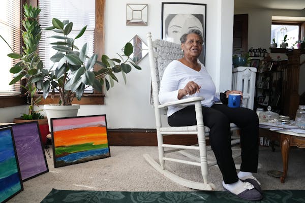Linda Taylor sits in the living room of her home Friday, April 8, in the Powderhorn Park neighborhood of Minneapolis. Taylor has lived her home for 18