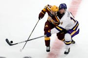 Minnesota State Mankato’s Ryan Sandelin and the Gophers’ Ben Meyers vied for the puck during the second period of their Frozen Four semifinal Thur