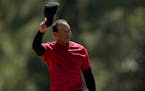 Tiger Woods tipped his cap on the 18th green Sunday at Augusta National.