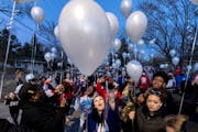 Katie Wright, the mother of Daunte Wright, and others release balloons at a vigil honoring Daunte Wright on the one-year anniversary of his death Mond