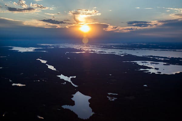 The chain of lakes in the Kabetogama Peninsula, center, and Rainy Lake, top, are seen during sunset at Voyageurs National Park in 2016.
