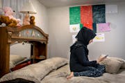 Sara spends a few moments in her room after she and her family broke fast on the second day of Ramadan at her home in Golden Valley on Monday, April 4