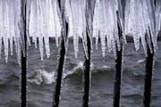 Ice formed on a metal hand rail as high winds whipped across Bde Maka Ska in Minneapolis on Thursday.