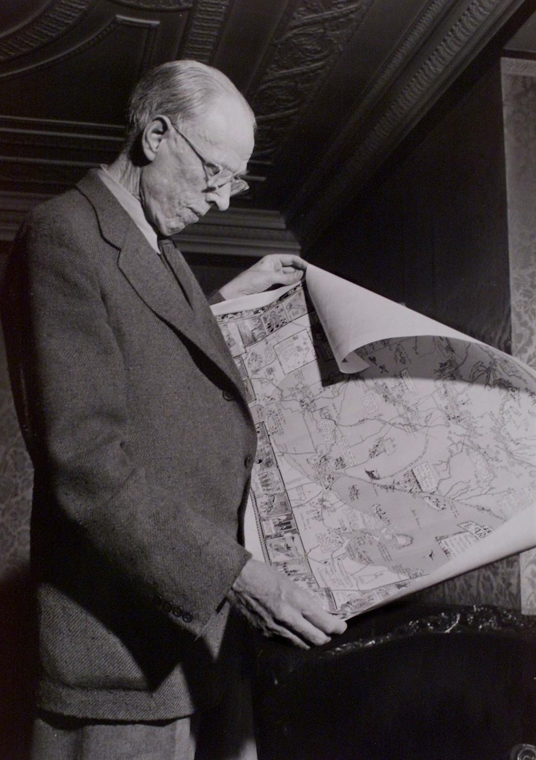 Historical photo of Sinclair Lewis looking at map of the Arrowhead region of Minnesota in 1944, when he was living and writing in Duluth.