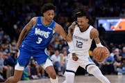 Memphis guard Ja Morant tried to fend off Timberwolves forward Jaden McDaniels during the first half during Game 1 