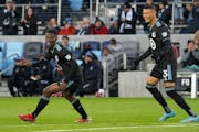 Minnesota United defender Bakaye Dibassy (12) and midfielder Kervin Arriaga (33) celebrate after Dibassy scored a goal in the first half Saturday