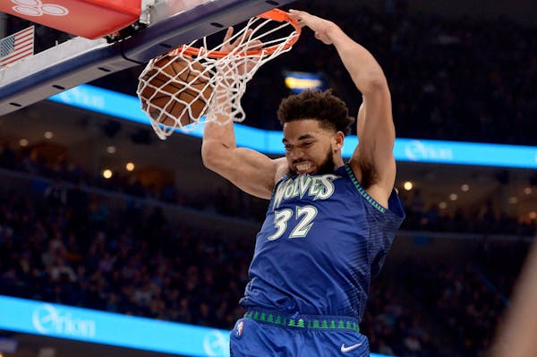 Minnesota Timberwolves center Karl-Anthony Towns (32) dunks the ball in the second half during Game 1 of a first-round NBA basketball playoff series a