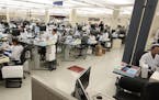 Lab workers logged in specimen samples at the Mayo Clinic Superior Drive facility on March 10, 2020, in Rochester.