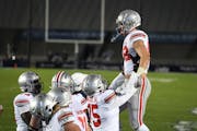 Ohio State tight end Jeremy Ruckert (being lifted) celebrates a fourth-quarter touchdown against Penn State in October 2020.