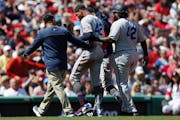 Minnesota Twins' Byron Buxton leaves the field after being injured on his double during the first inning of a baseball game against the Boston Red Sox