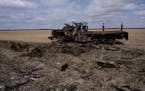 A Russian military vehicle destroyed during combats against Ukrainian army is seen in a corn field in Sytnyaky, on the outskirts of Kyiv, Ukraine, on 