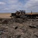 A Russian military vehicle destroyed during combats against Ukrainian army is seen in a corn field in Sytnyaky, on the outskirts of Kyiv, Ukraine, on 