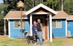 John Olafson and his wife, Staci, and their dog, Samson, in front of their tiny house.