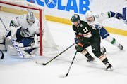 Wild left wing Kevin Fiala wraps around the back of the net before scoring a goal against Vancouver goaltender Thatcher Demko during the third period 