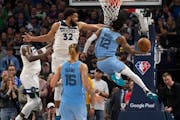 Wolves center Karl-Anthony Towns attempted to stop fellow All-Star Ja Morant as the Grizzlies guard drove to the basket late in Saturday’s playoff g
