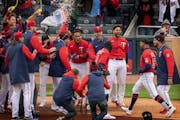 The Twins’ Byron Buxton (25) got quite the reception at home plate from teammates after clubbing a three-run walk-off homer in the bottom of the 10t