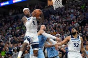 arred Vanderbilt, left, grabs a rebound before Memphis Grizzlies guard Dillon Brooks can get to it, while Timberwolves center Karl-Anthony Towns (32) 