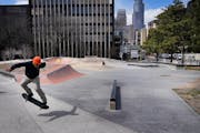 A skateboarder came out with the sun at Elliot Skate Plaza in Minneapolis on Tuesday. A pop-up skate park planned for the north parking lot of Bde Mak